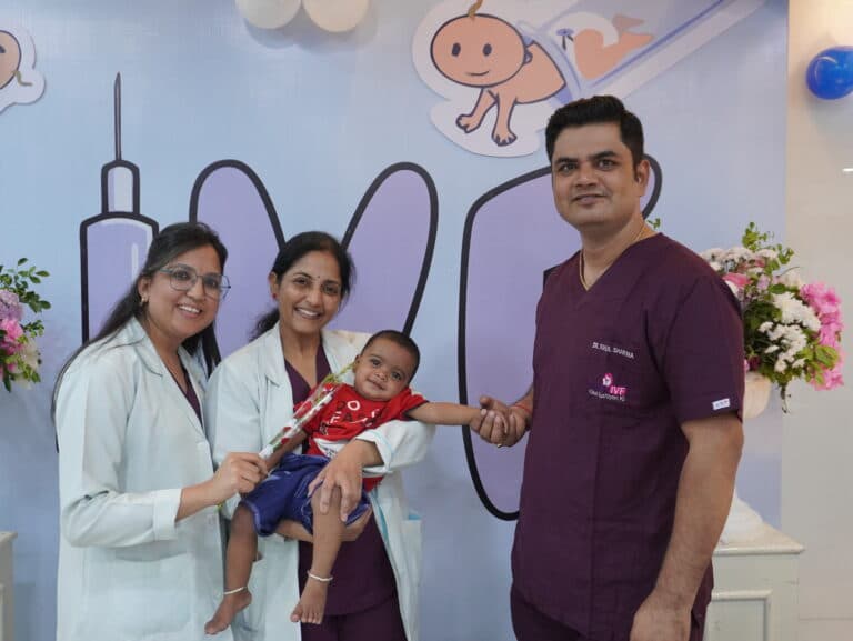 The Ishwa IVF team with a family and their baby at the clinic